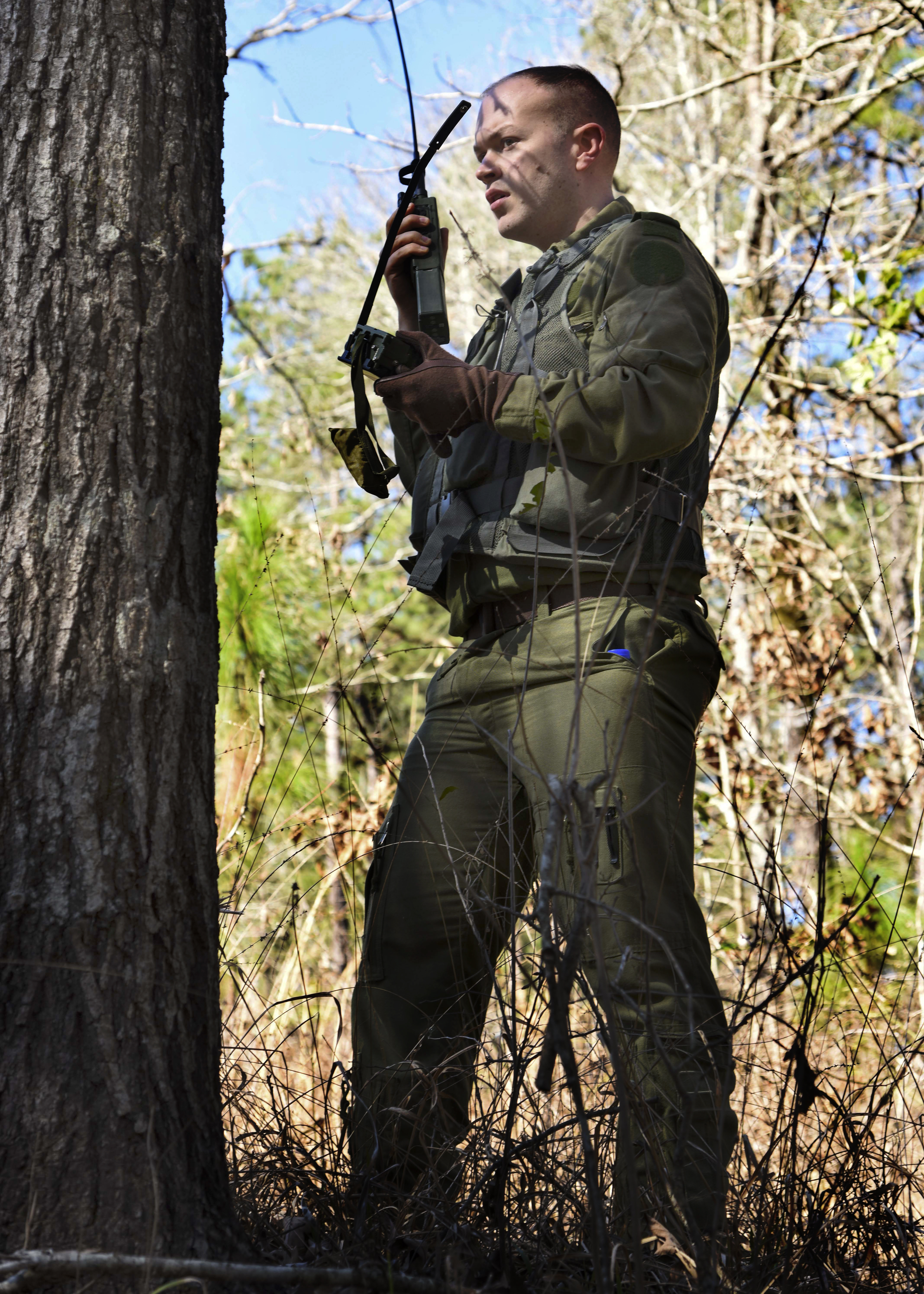 Royal Canadian Air Force Cpl. Teddy Lapkin, 436 Transport Squadron technical crewman, attempts to contact a C-130J during survival, evasion, resistance and escape training Feb. 10, 2017, near Alexandria, La. SERE training is conducted to aid aircrew in survival techniques such as building shelter, land navigation and procuring water to evade the enemy until they can be rescued. (U.S. Air Force photo by Senior Airman Stephanie Serrano)